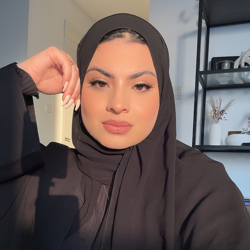 Golden-hour portrait of Aliya in a black hijab